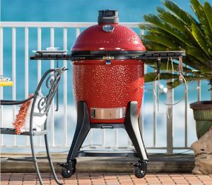 red small grill on back deck in the summer